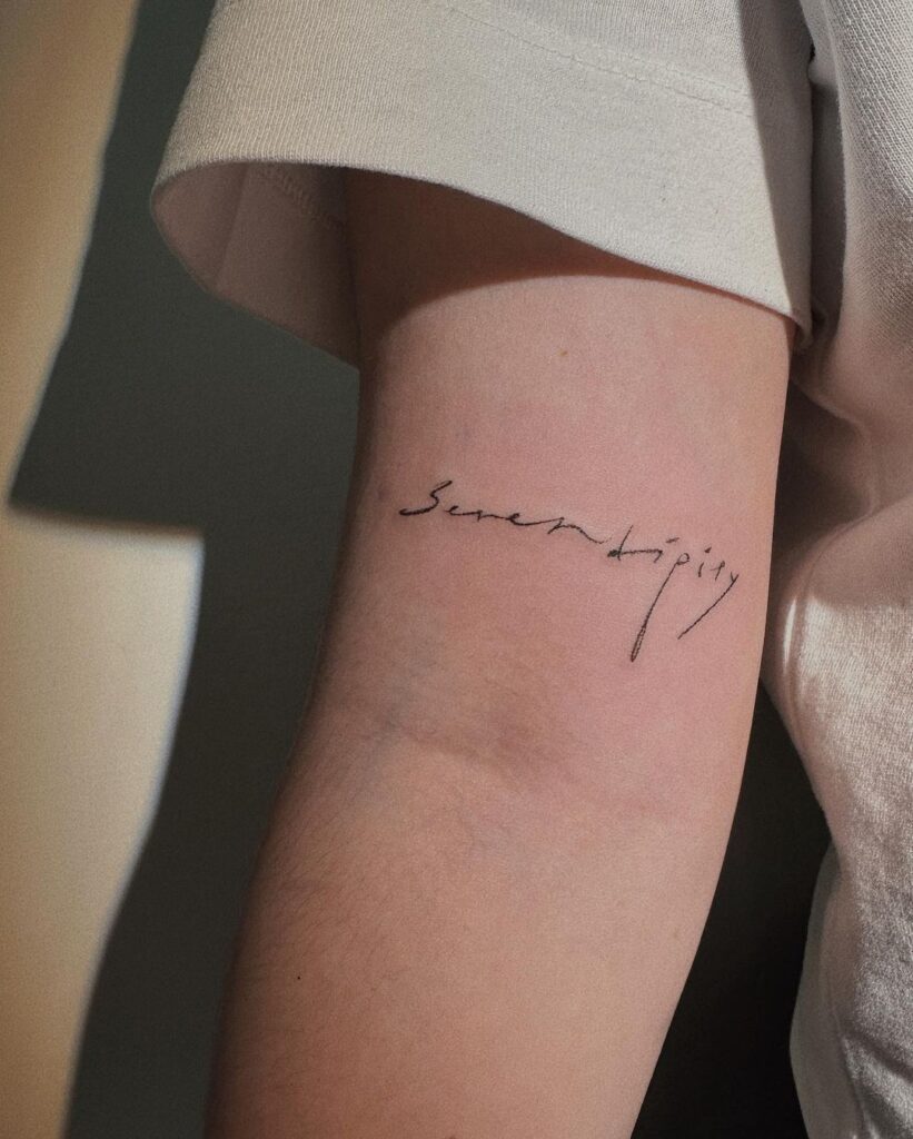 Een "serendipity" tattoo op de bovenarm